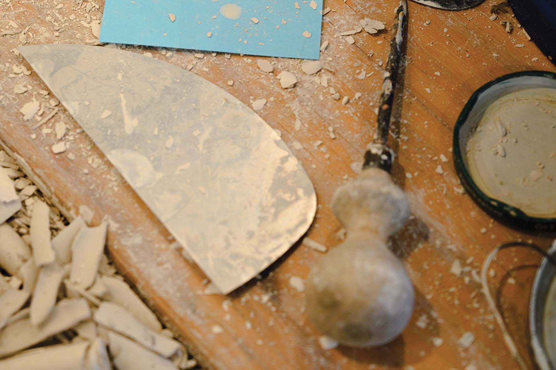 a spatula and a piece of wood on a table