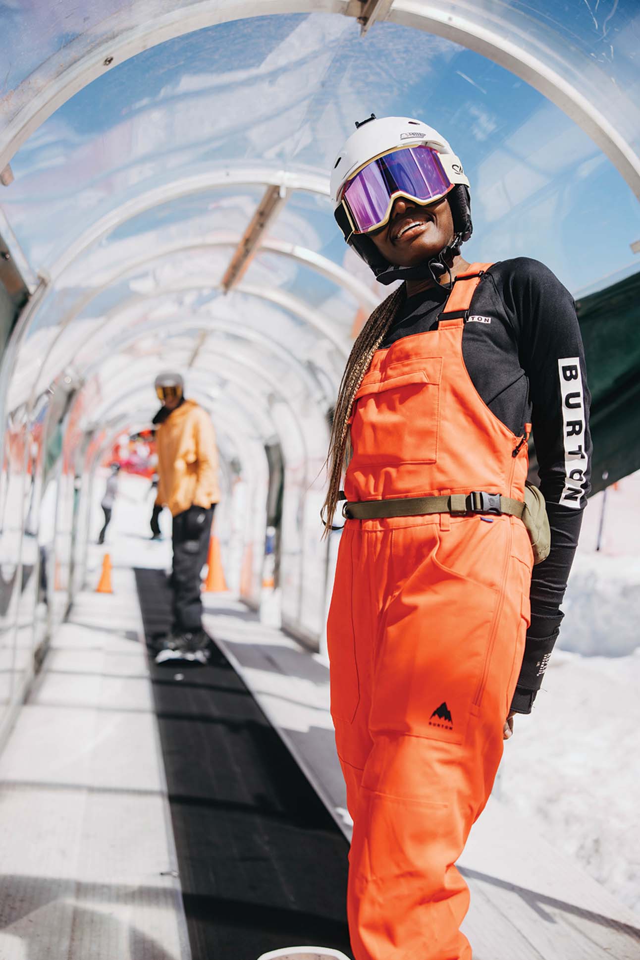 a person wearing orange overalls and goggles