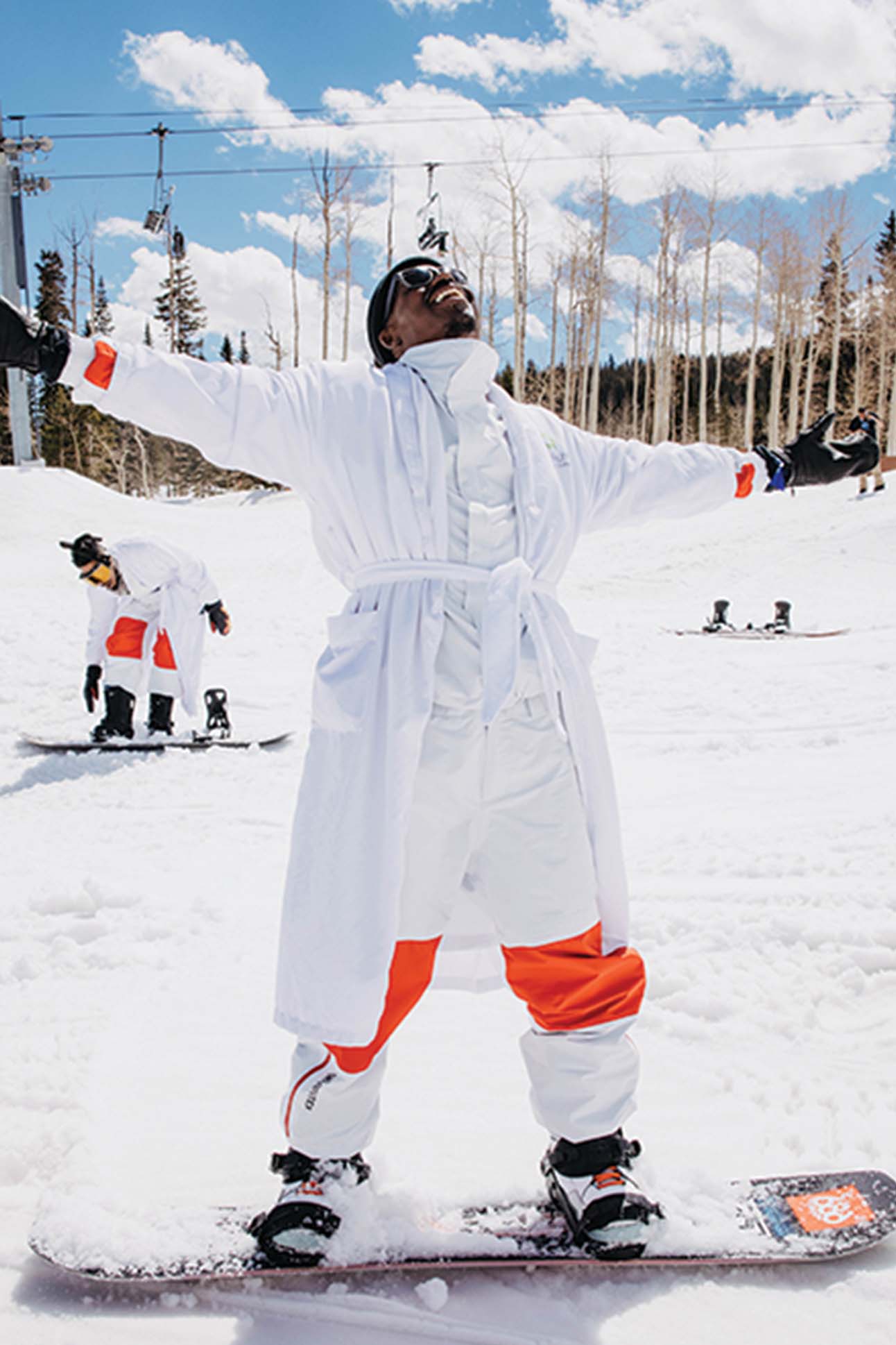 a person in white coat with arms outstretched in the air