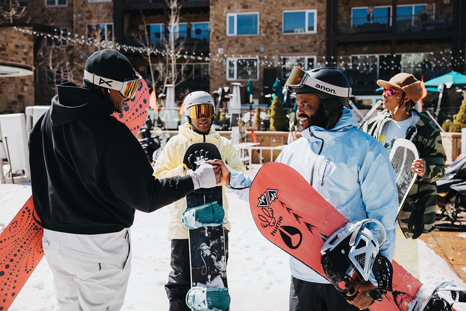 a group of people shaking hands with snowboards