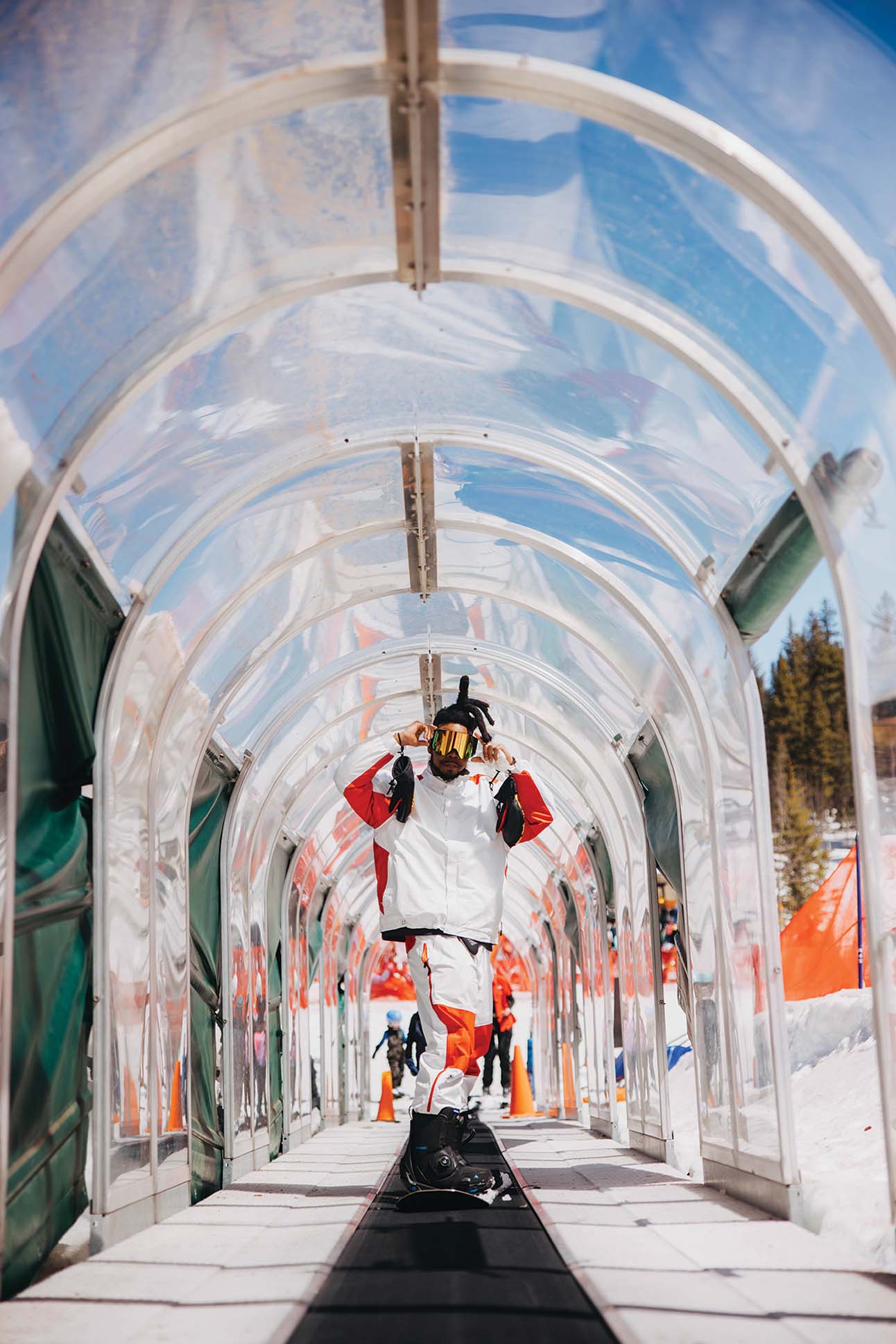 a person in a white and red outfit standing in a tunnel