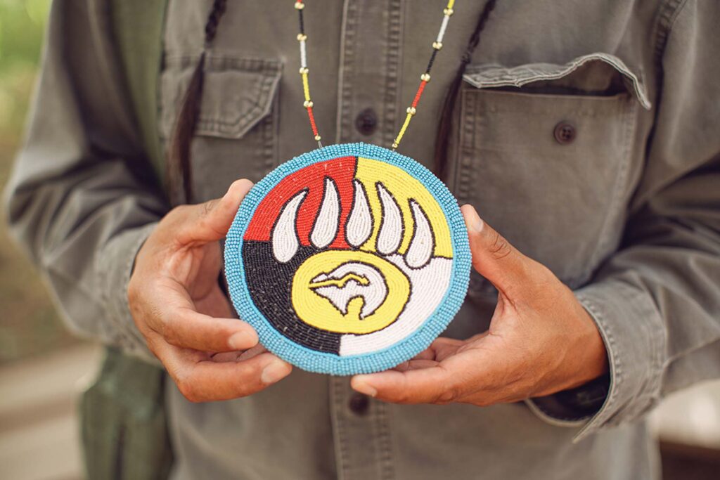 a person holding a beaded necklace