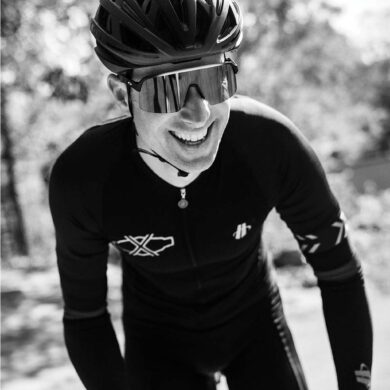 Christian Vande Velde wearing a helmet and sunglasses, cycling