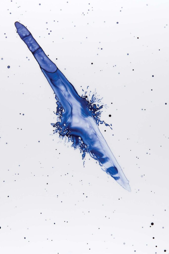 a blue liquid splashing out