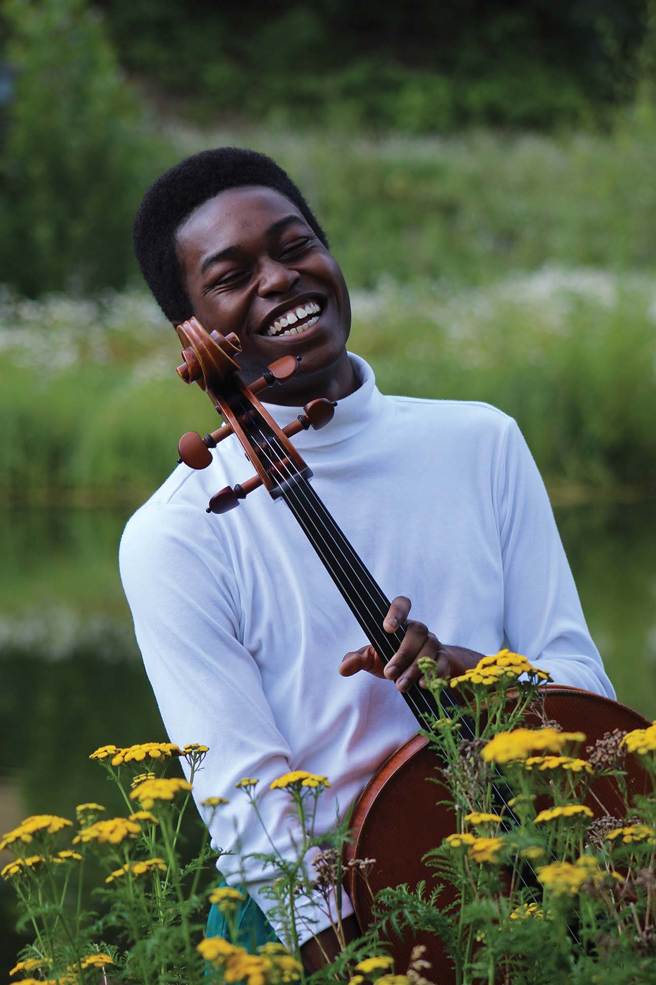 a person smiling while playing a violin