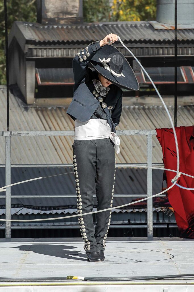 a person wearing a hat and a suit