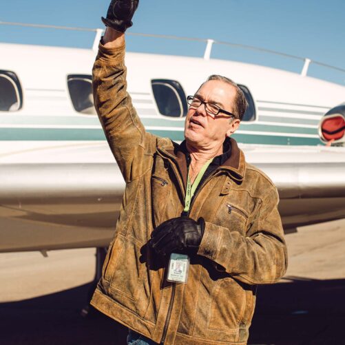 a person standing in front of a plane