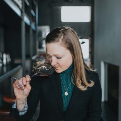 a person drinking from a wine glass